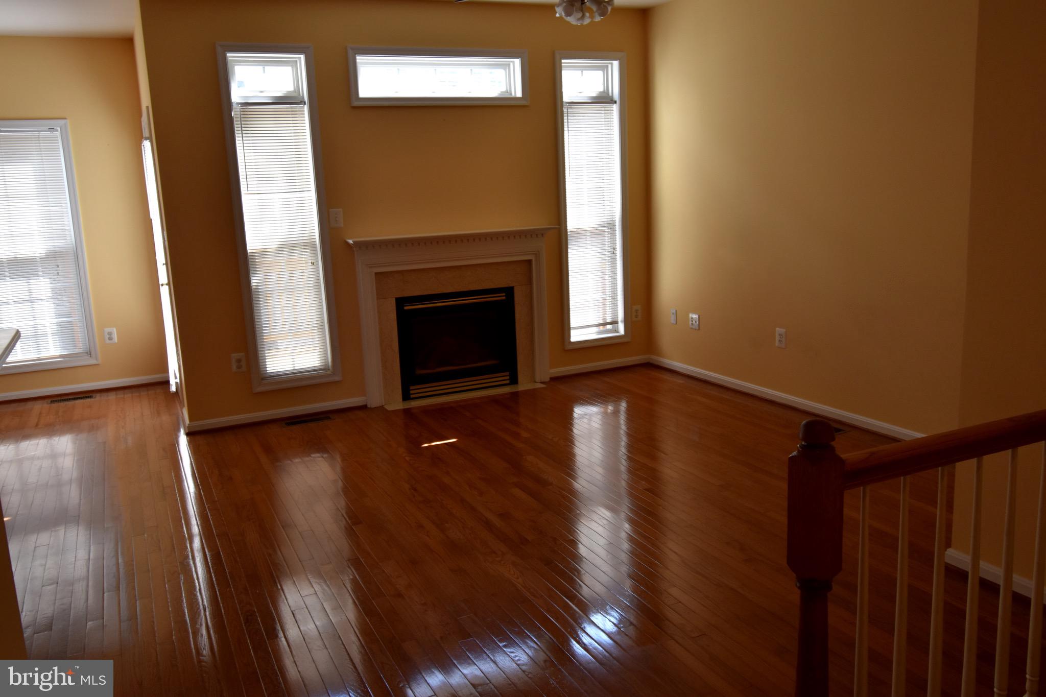 13571 Cedar Run Lane Herndon, VA 20171 - Photo 10 of 33 a view of an empty room with wooden floor and a window