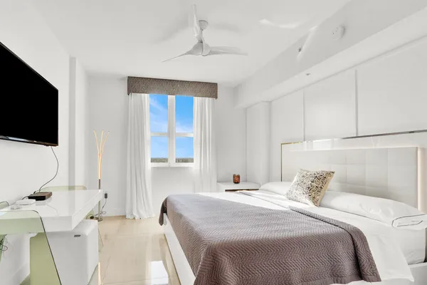 a bedroom with a large bed and a window