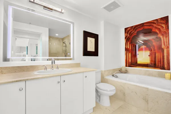 a bathroom with a tub and shower