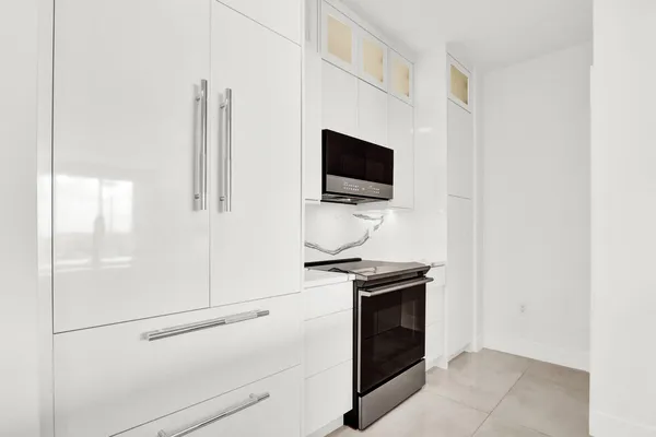 a hallway with a stove and a microwave