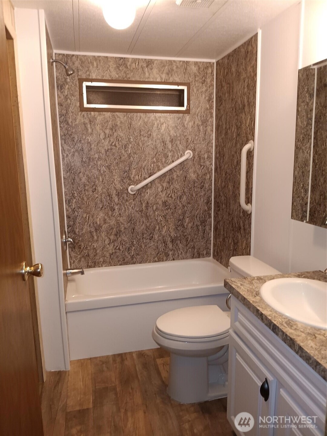 1841 Trosper Road Southwest, Unit 32 Tumwater, WA 98512 - Photo 11 of 13 a bathroom with a granite countertop bathtub shower sink vanity and toilet