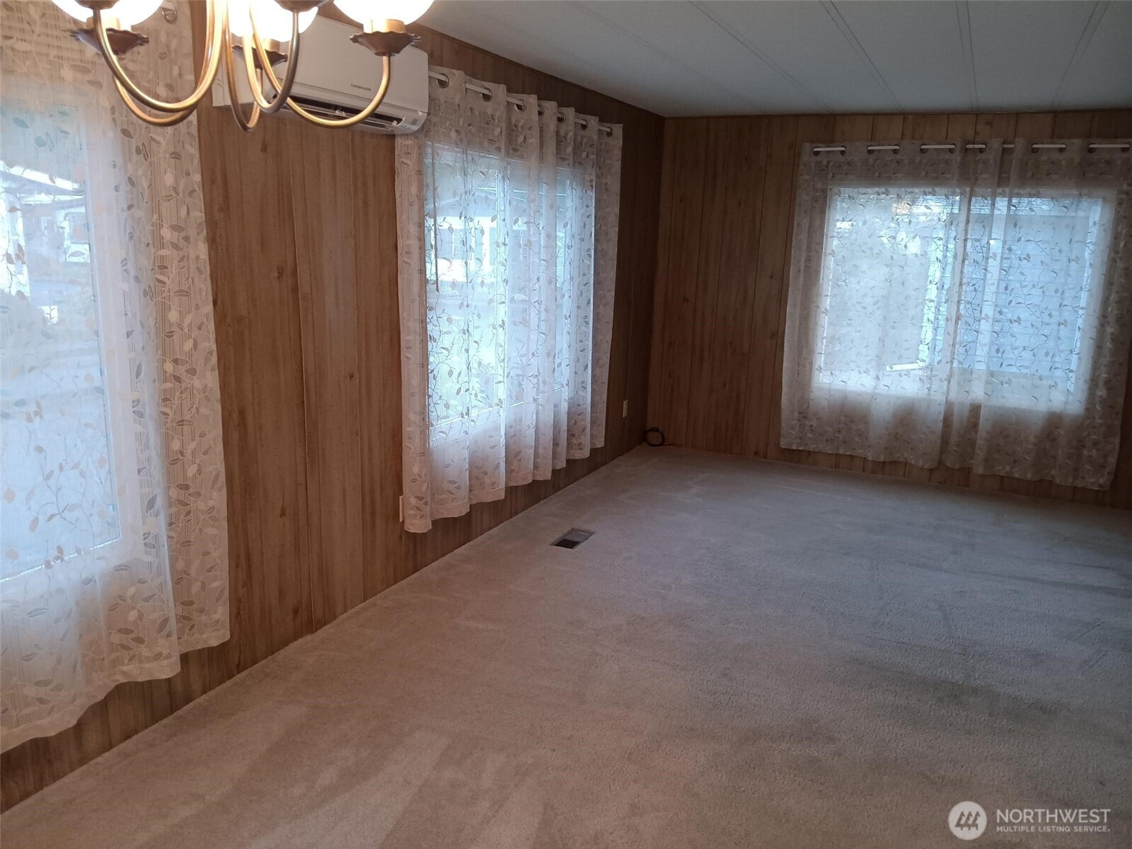 1841 Trosper Road Southwest, Unit 32 Tumwater, WA 98512 - Photo 7 of 13 a view of a room with a large window and wooden floor