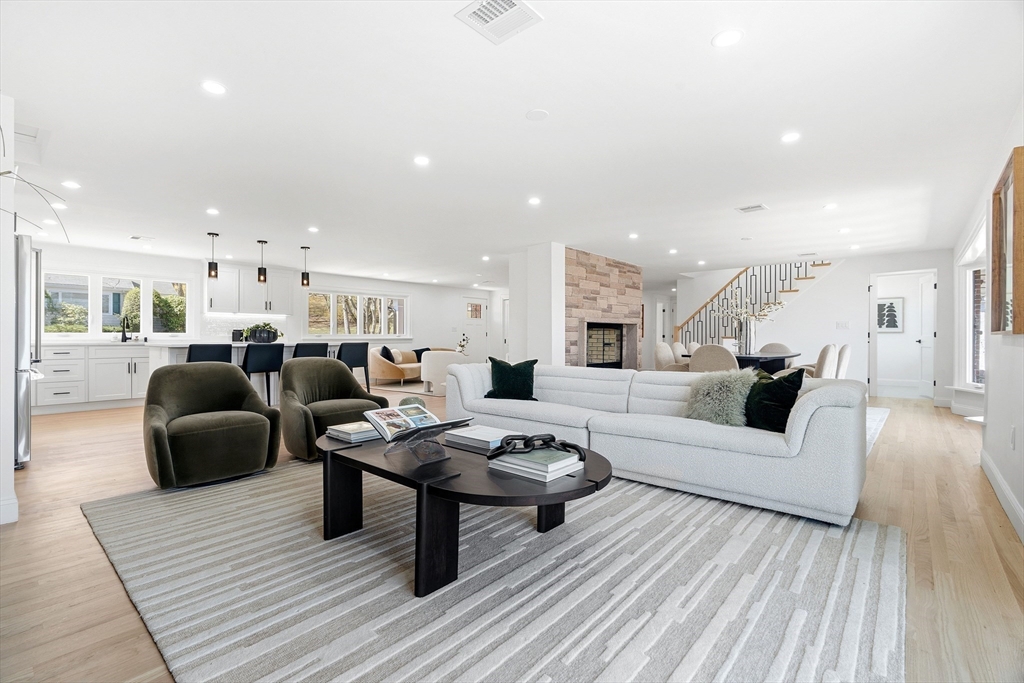 171 Shaw Road Brookline, MA 02467 - Photo 9 of 42 a living room with furniture a wooden floor and a chandelier