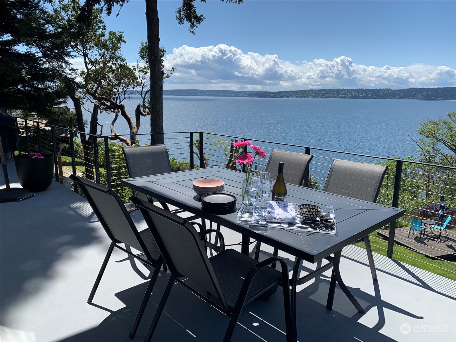 a table and chairs with the view of potted plants