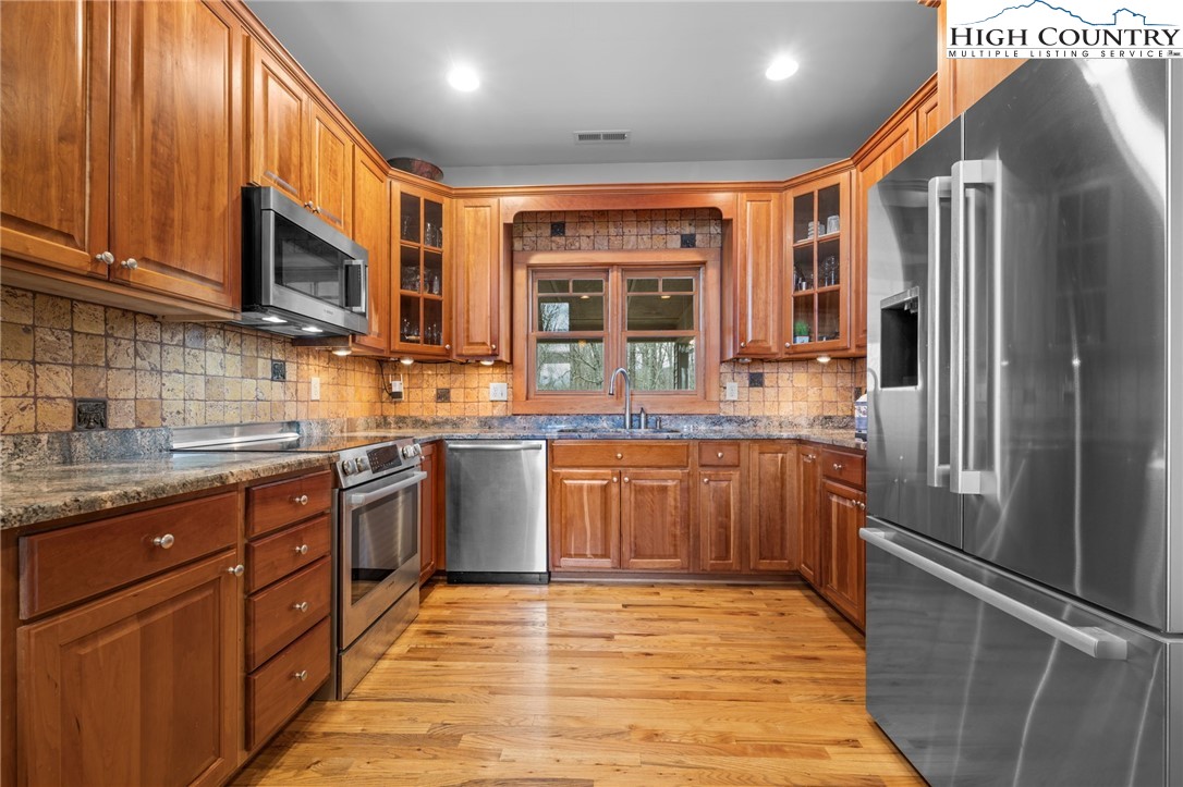 1690 Evergreen Drive Boone, NC 28607 - Photo 14 of 47 a kitchen with stainless steel appliances granite countertop a refrigerator a stove top oven a sink and dishwasher