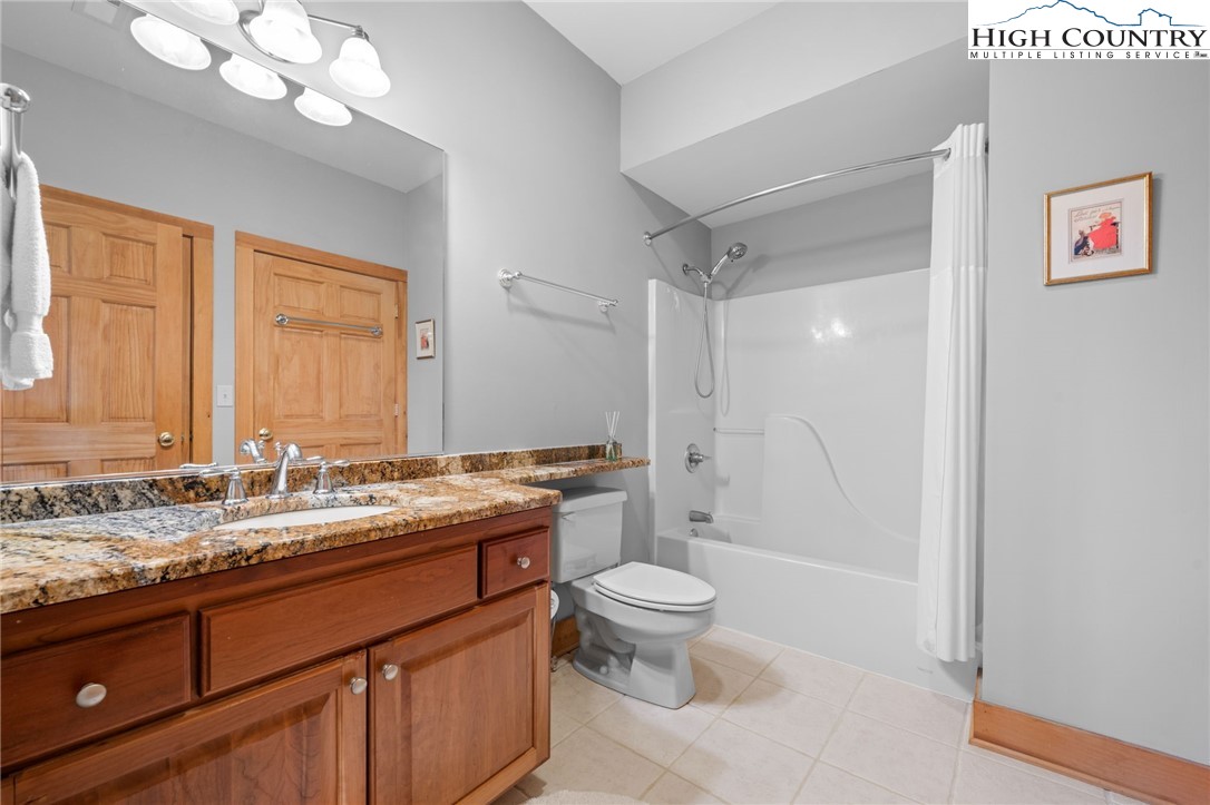 1690 Evergreen Drive Boone, NC 28607 - Photo 20 of 47 a bathroom with a granite countertop sink mirror vanity and toilet