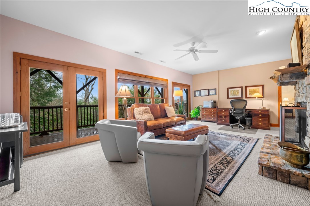 1690 Evergreen Drive Boone, NC 28607 - Photo 21 of 47 a living room with furniture a floor to ceiling window and flat screen tv