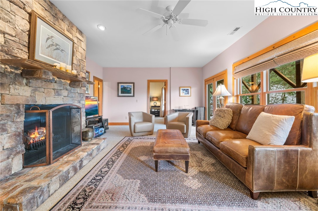 1690 Evergreen Drive Boone, NC 28607 - Photo 23 of 47 a living room with furniture a large window and a fireplace