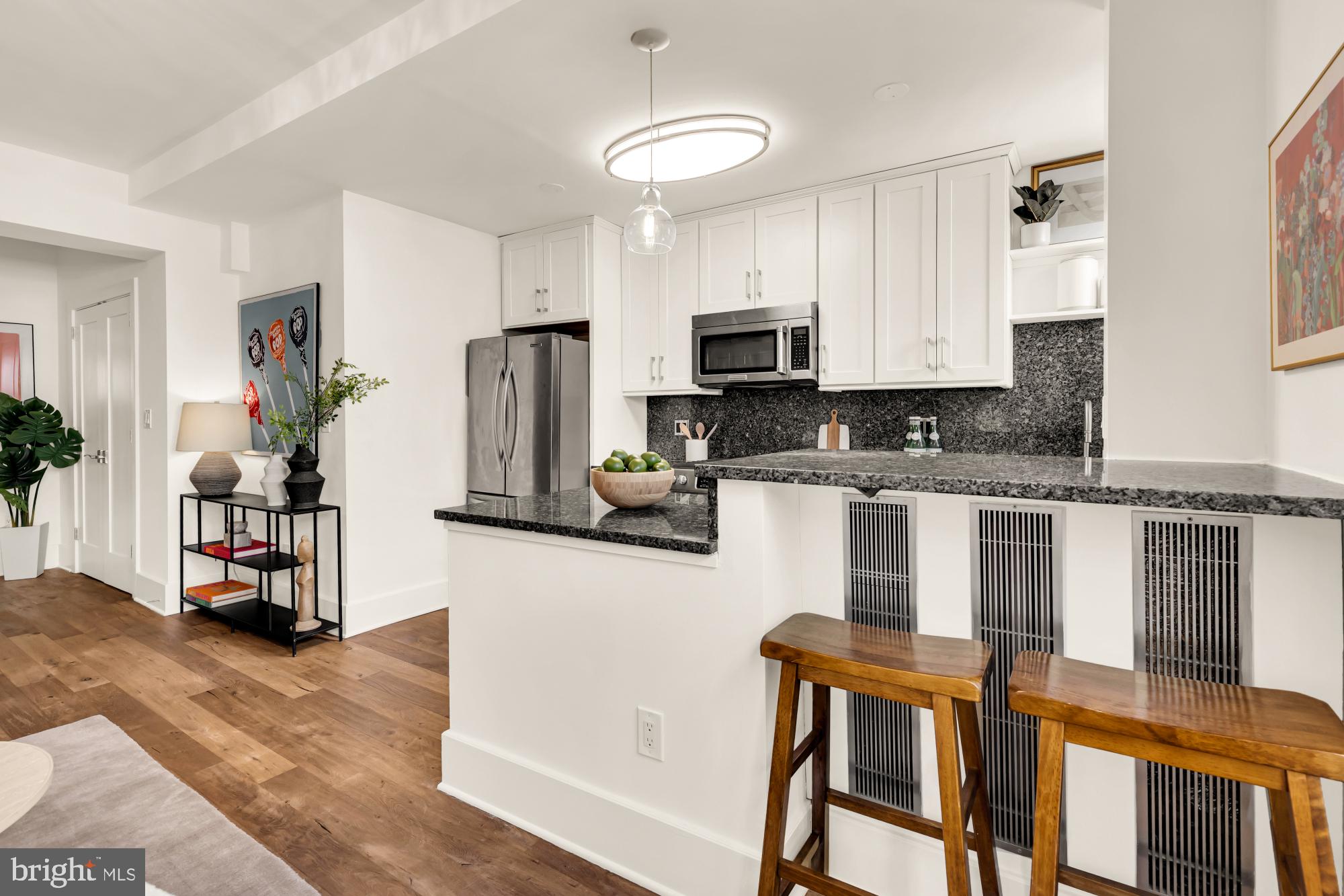 1910 Kalorama Road Northwest, Unit 302 Washington, DC 20009 - Photo 17 of 28 a kitchen with stainless steel appliances granite countertop a stove a sink a refrigerator white cabinets and wooden floor