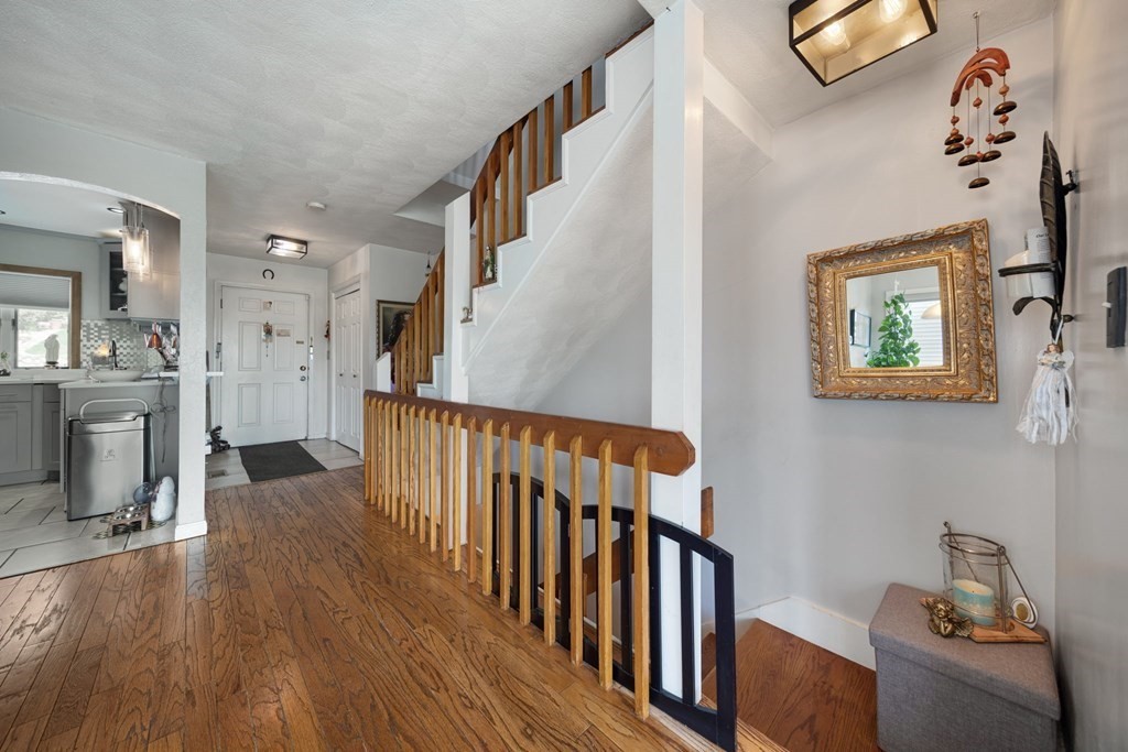 80 Ridge Road, Unit 80 Revere, MA 02151 - Photo 11 of 41 a view of a hallway with wooden floor and staircase