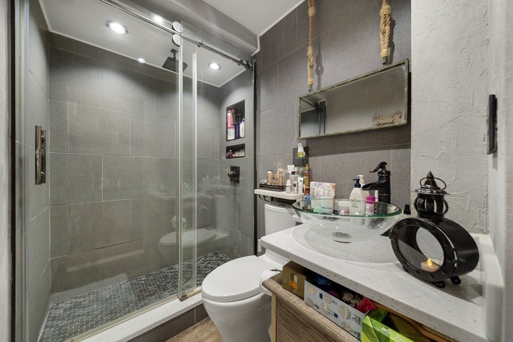 80 Ridge Road, Unit 80 Revere, MA 02151 - Photo 14 of 41 a bathroom with a sink a toilet and a shower