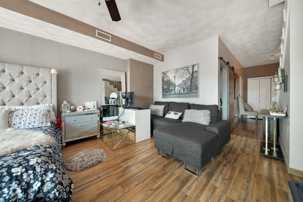 80 Ridge Road, Unit 80 Revere, MA 02151 - Photo 22 of 41 a living room with furniture and a wooden floor