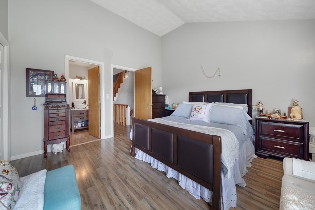 80 Ridge Road, Unit 80 Revere, MA 02151 - Photo 27 of 41 a bedroom with a bed and wooden floor