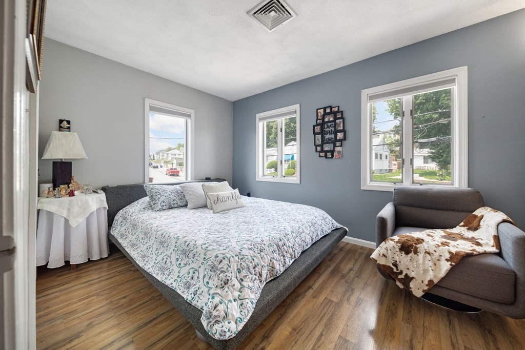 80 Ridge Road, Unit 80 Revere, MA 02151 - Photo 31 of 41 a bedroom with a bed and wooden floor