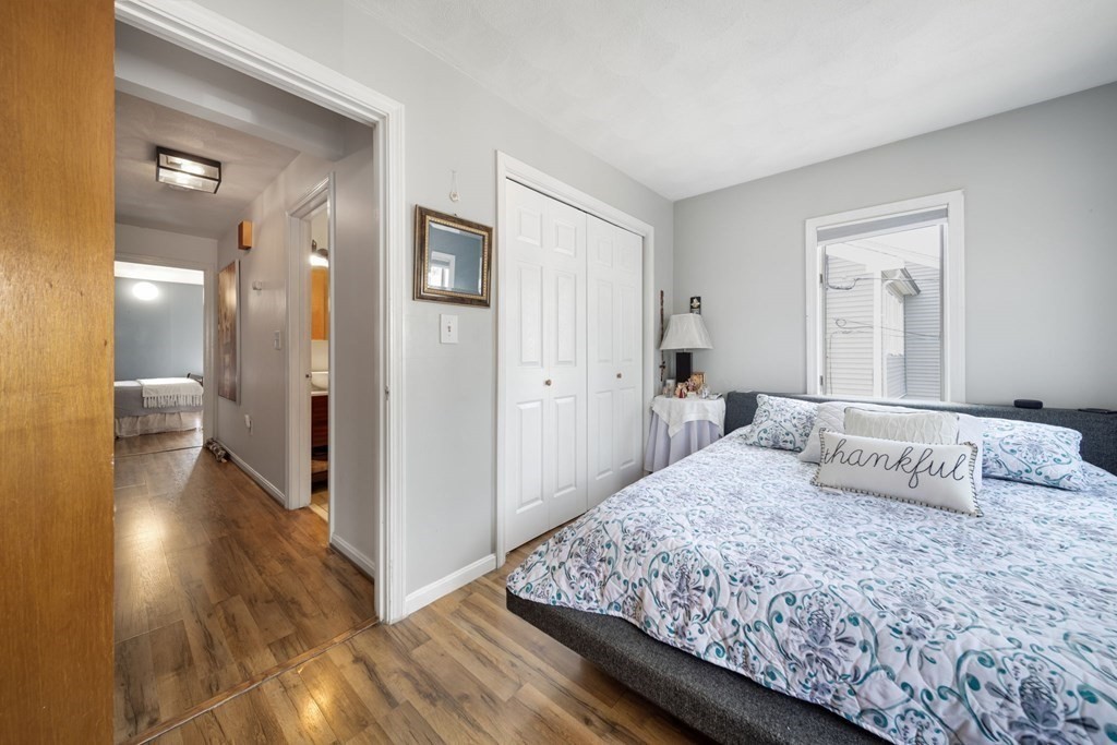 80 Ridge Road, Unit 80 Revere, MA 02151 - Photo 32 of 41 a bedroom with a large bed and wooden floor