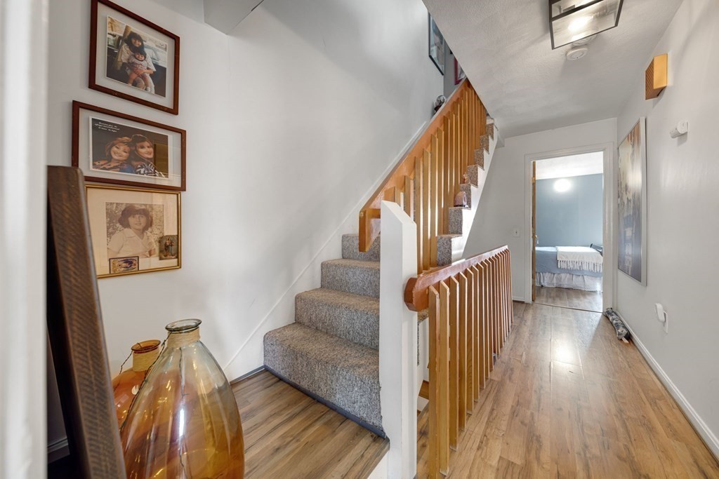 80 Ridge Road, Unit 80 Revere, MA 02151 - Photo 34 of 41 a view of a hallway with wooden floor and stairs