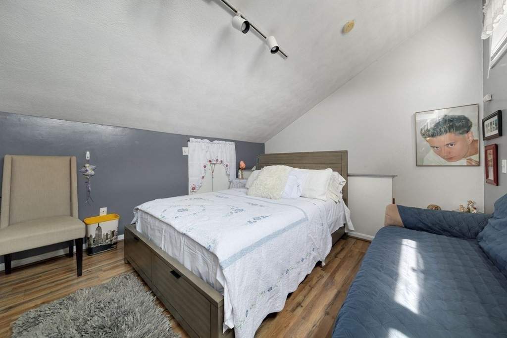 80 Ridge Road, Unit 80 Revere, MA 02151 - Photo 36 of 41 a bed room with a bed and a couch