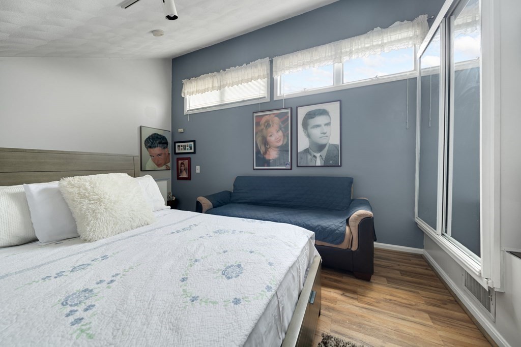 80 Ridge Road, Unit 80 Revere, MA 02151 - Photo 37 of 41 a bedroom with a bed and wooden floor