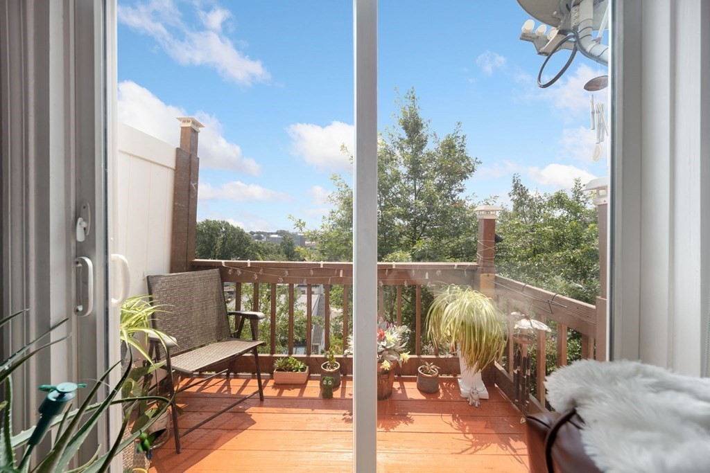 80 Ridge Road, Unit 80 Revere, MA 02151 - Photo 4 of 41 a view of a balcony with couch and wooden floor