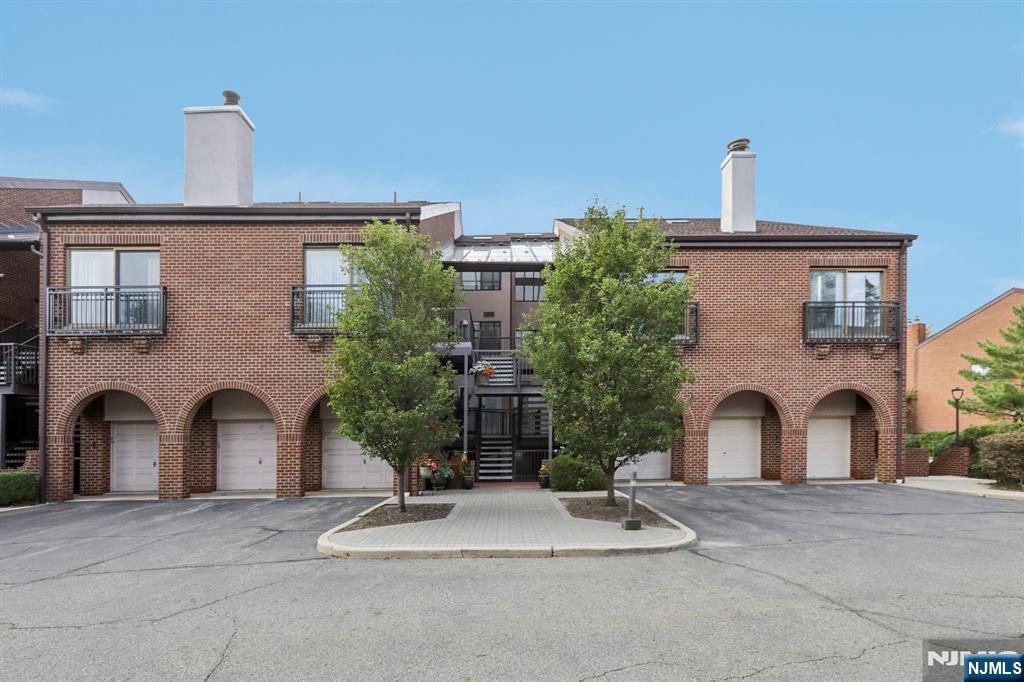 5 Millay Court Teaneck, NJ 07666 - Photo 1 of 36 a front view of a house with a yard and garage