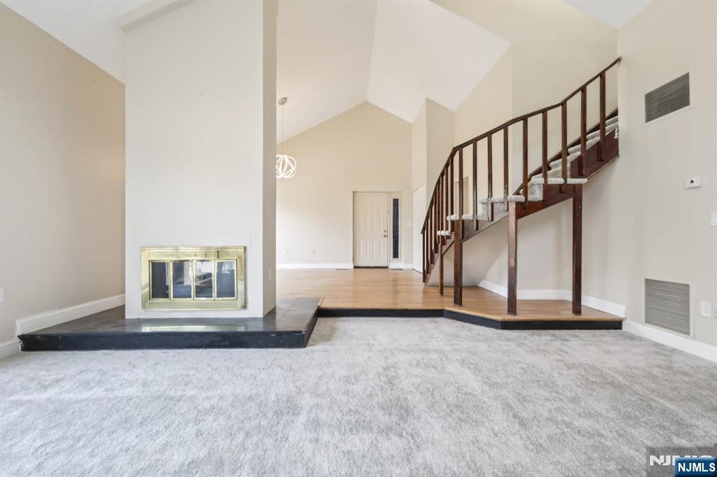 5 Millay Court Teaneck, NJ 07666 - Photo 12 of 36 a view of an empty room with staircase and a window