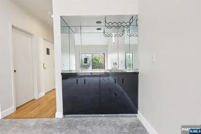 a kitchen with a refrigerator sink and cabinets