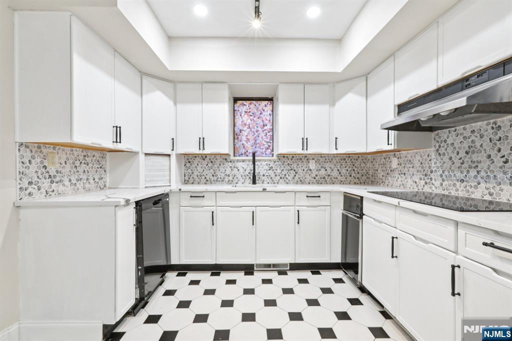 5 Millay Court Teaneck, NJ 07666 - Photo 15 of 36 a kitchen with a sink a stove cabinets and a window
