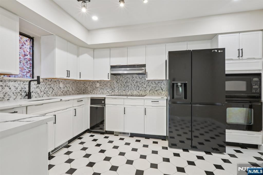 5 Millay Court Teaneck, NJ 07666 - Photo 16 of 36 a kitchen with a refrigerator sink and cabinets