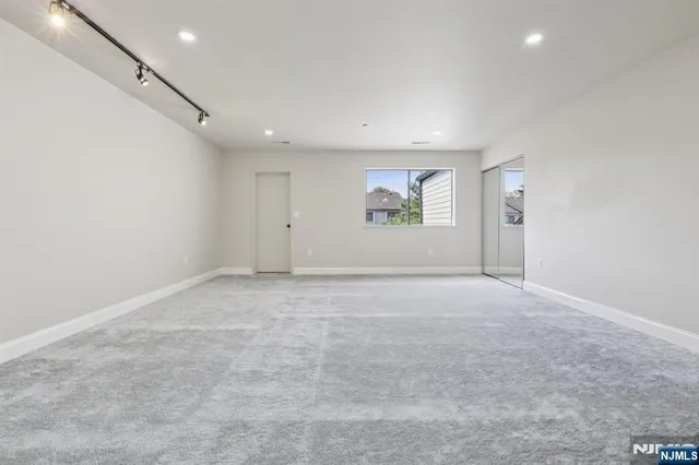 a bathroom with a tub a sink and mirror