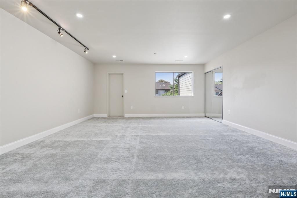 5 Millay Court Teaneck, NJ 07666 - Photo 18 of 36 an empty room with windows