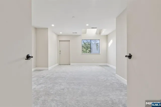 an empty room with windows and closet