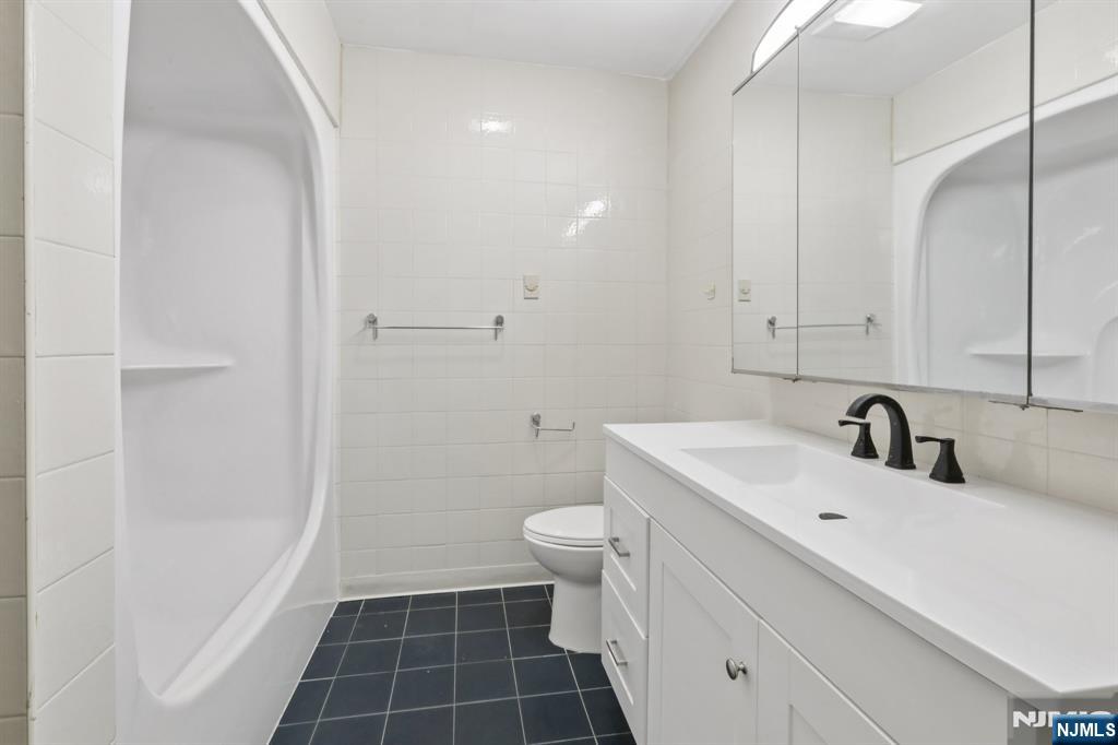 5 Millay Court Teaneck, NJ 07666 - Photo 29 of 36 a bathroom with a sink toilet and shower