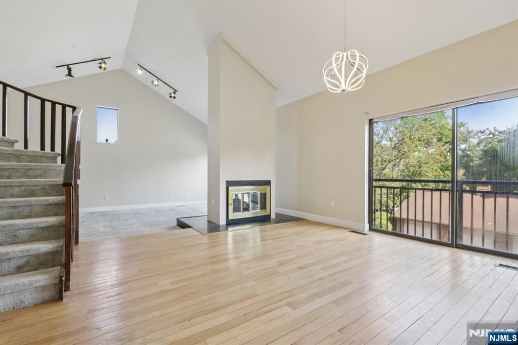 5 Millay Court Teaneck, NJ 07666 - Photo 7 of 36 a view of empty room with wooden floor and fan
