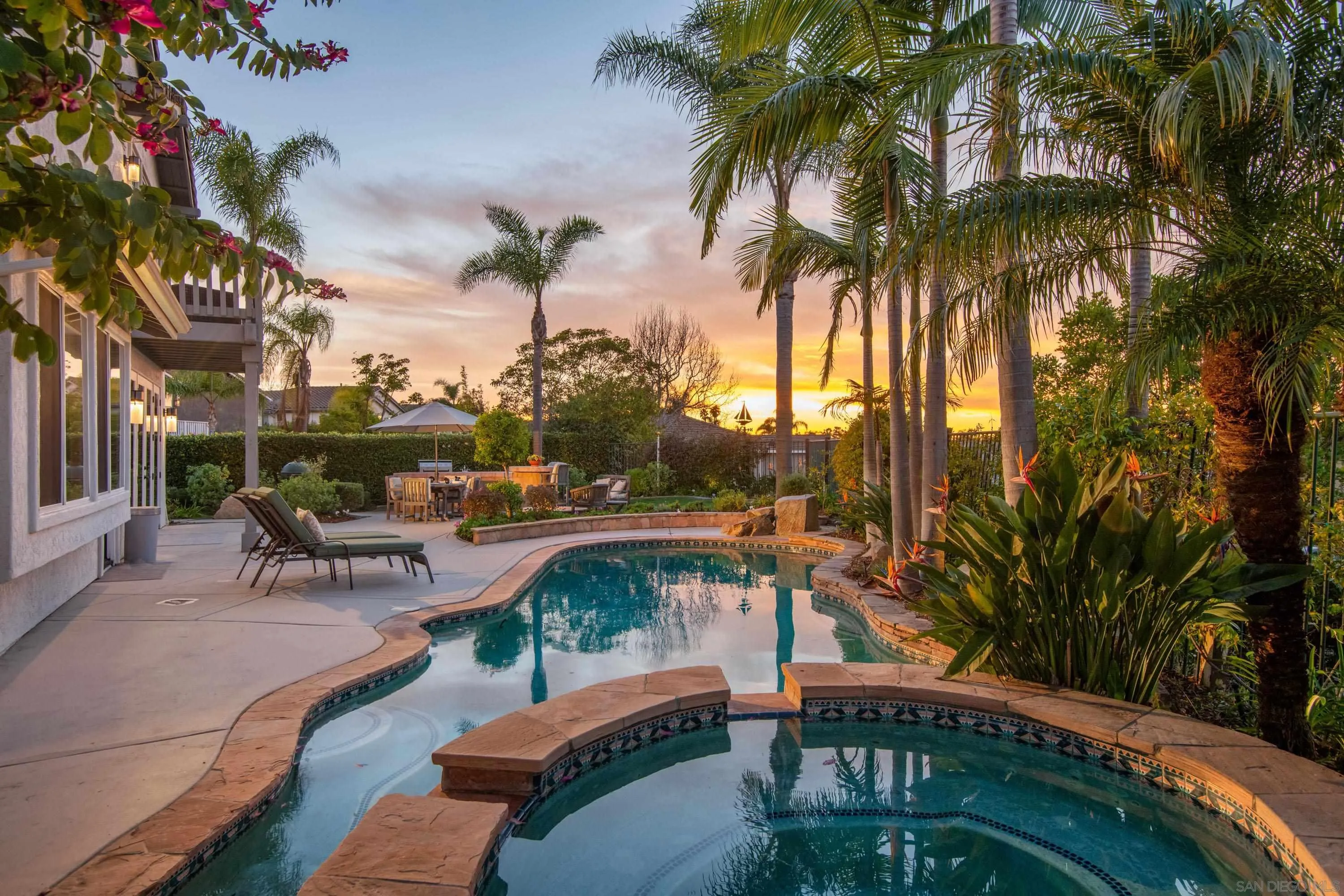 3476 Corte Sonrisa Carlsbad, CA 92009 - Photo 2 of 45 a view of a swimming pool with a table and chairs