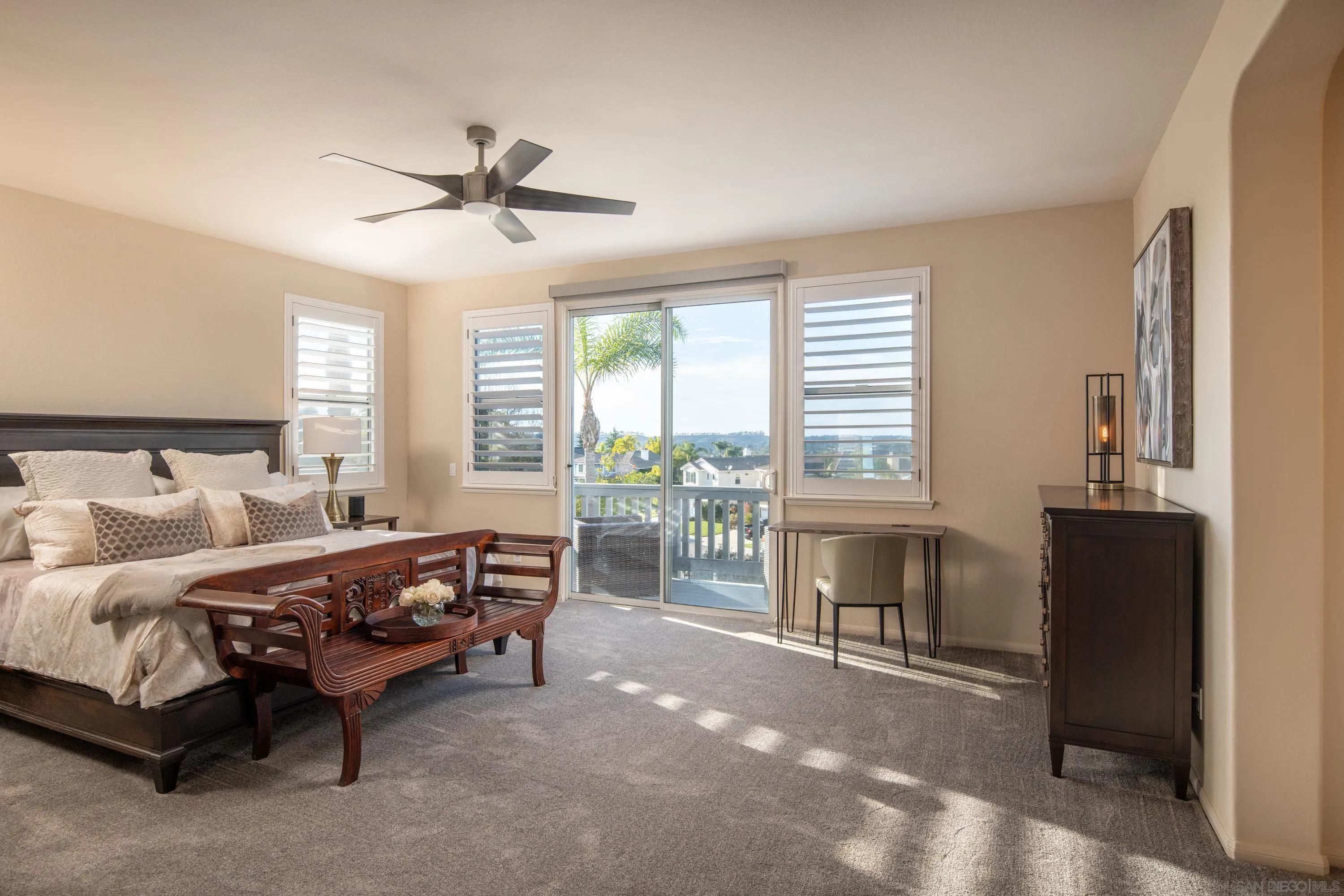 3476 Corte Sonrisa Carlsbad, CA 92009 - Photo 23 of 45 a bedroom with a bed and a chandelier