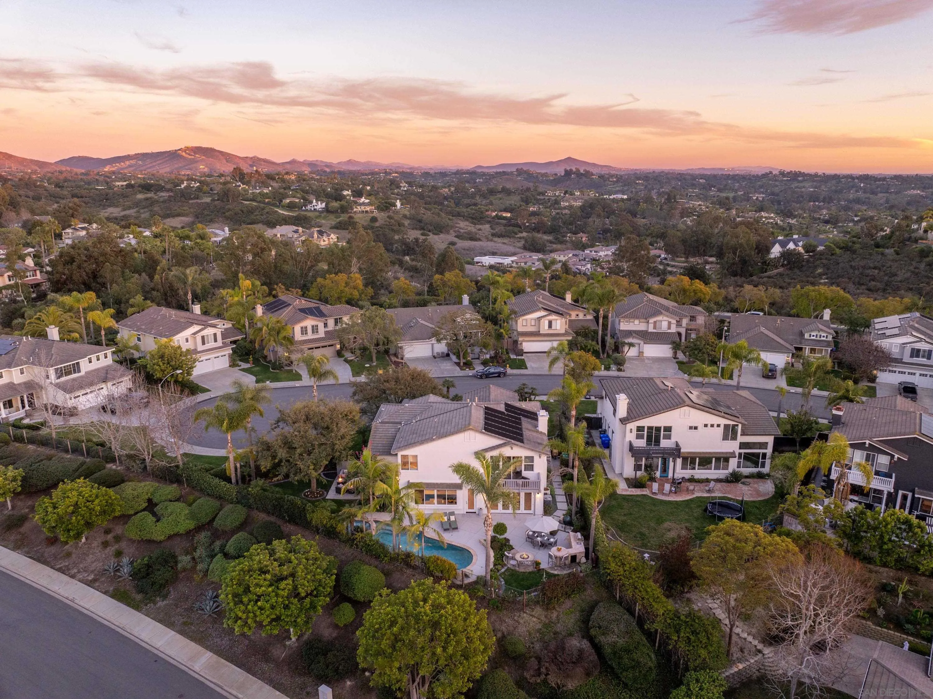 3476 Corte Sonrisa Carlsbad, CA 92009 - Photo 34 of 45 an aerial view of a city with lots of residential buildings and mountain view in back