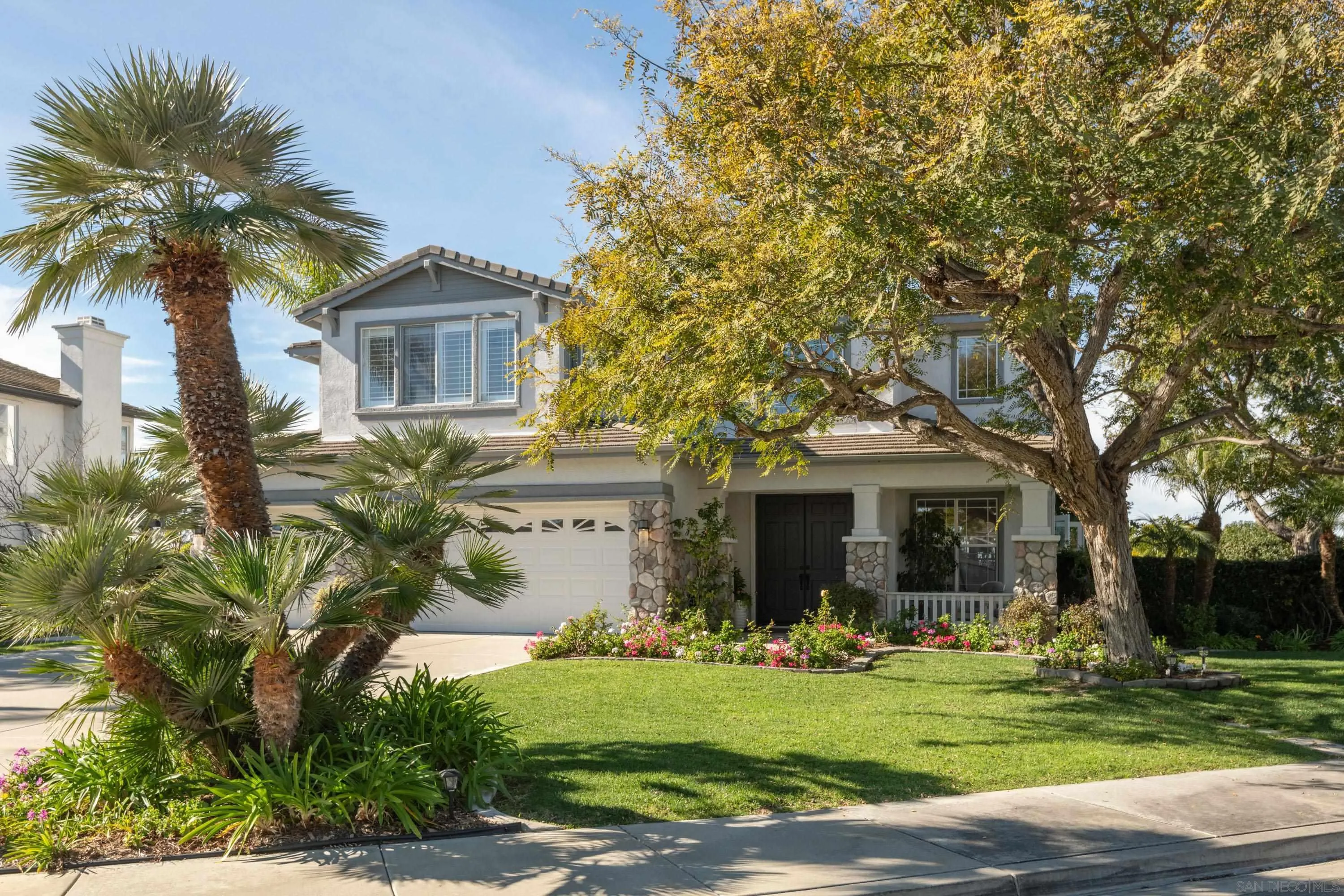 3476 Corte Sonrisa Carlsbad, CA 92009 - Photo 39 of 45 a front view of a house with garden and trees