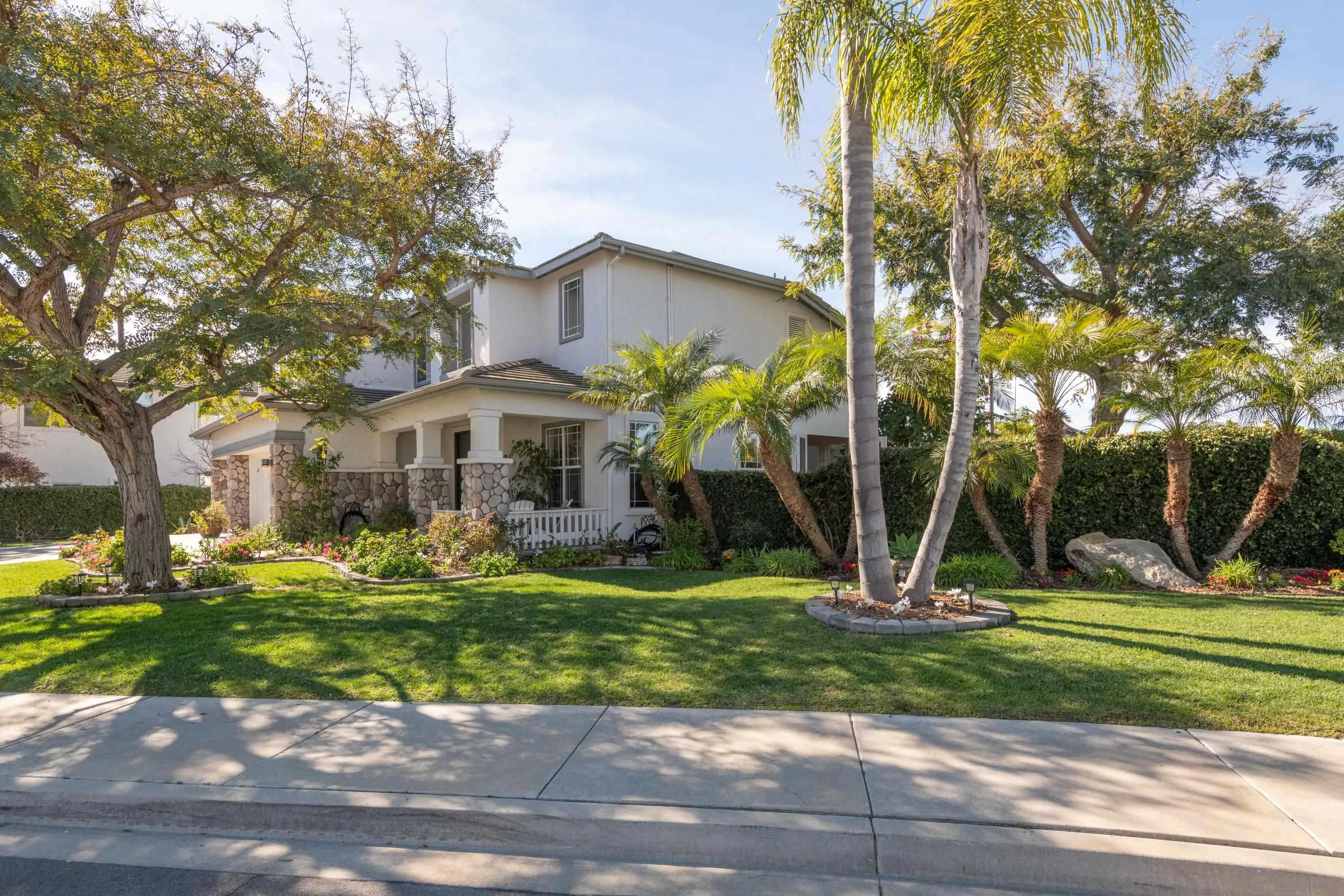 3476 Corte Sonrisa Carlsbad, CA 92009 - Photo 40 of 45 a front view of a house with garden and trees