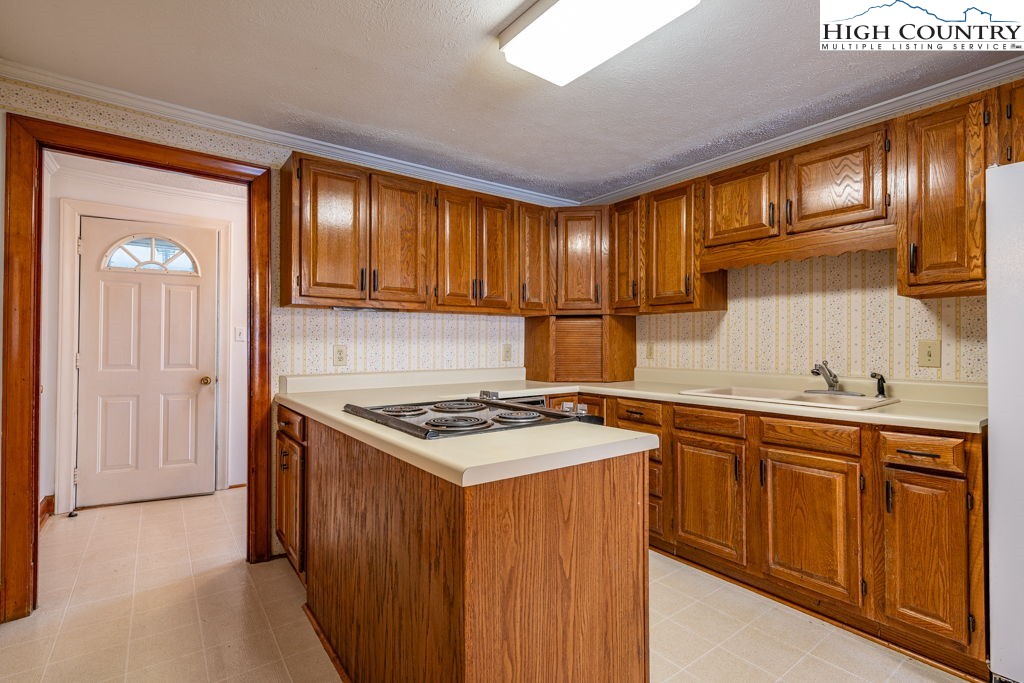 268 Farthing Street Boone, NC 28607 - Photo 12 of 30 a kitchen with a stove sink and cabinets