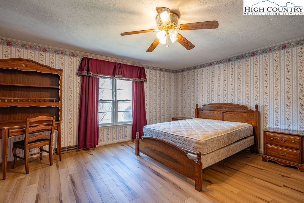 268 Farthing Street Boone, NC 28607 - Photo 17 of 30 a bedroom with a bed and a chandelier