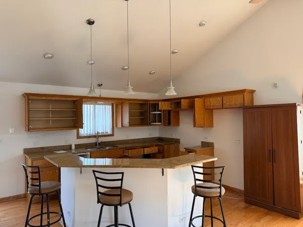 a kitchen with stainless steel appliances granite countertop a sink and cabinets
