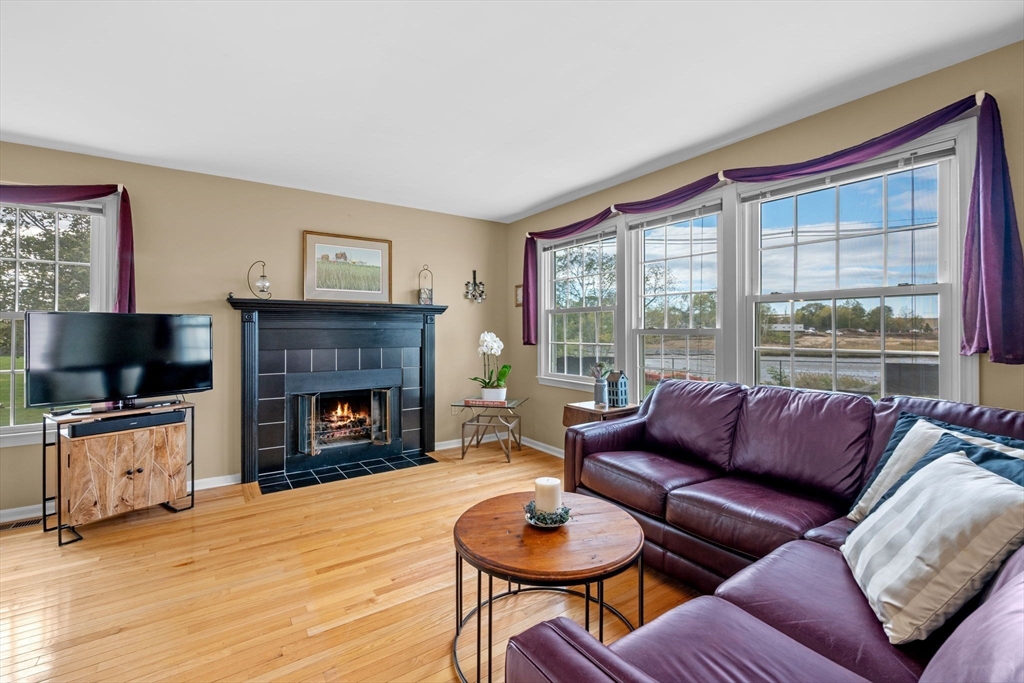 33 Water Street, Unit 7 Danvers, MA 01923 - Photo 12 of 35 a living room with furniture a flat screen tv and a fireplace