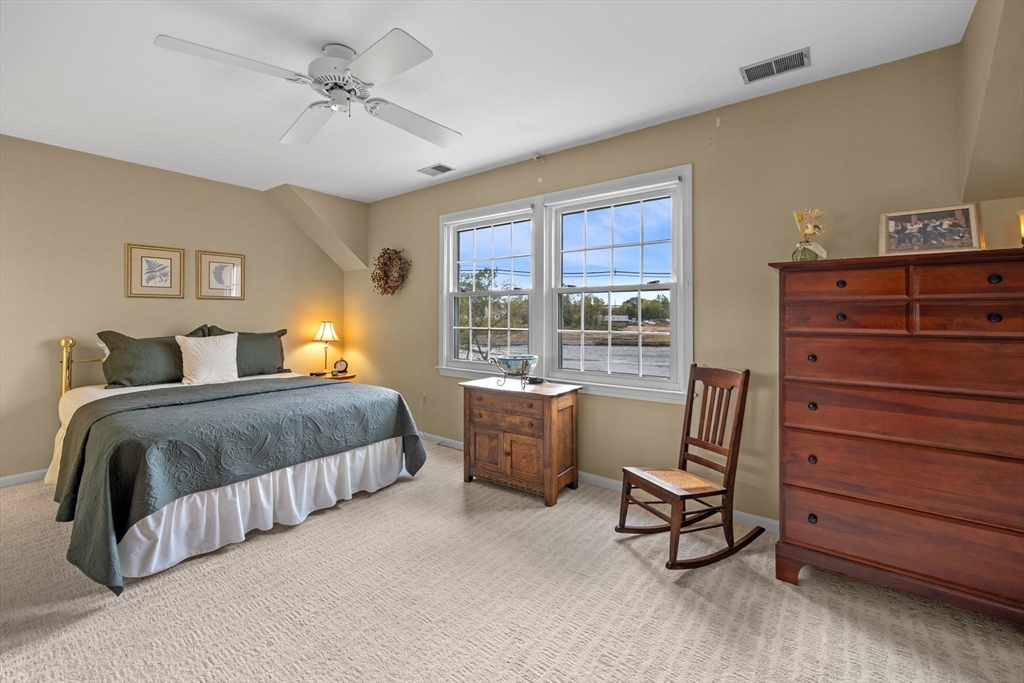 33 Water Street, Unit 7 Danvers, MA 01923 - Photo 19 of 35 a spacious bedroom with a bed a chair and next to a window