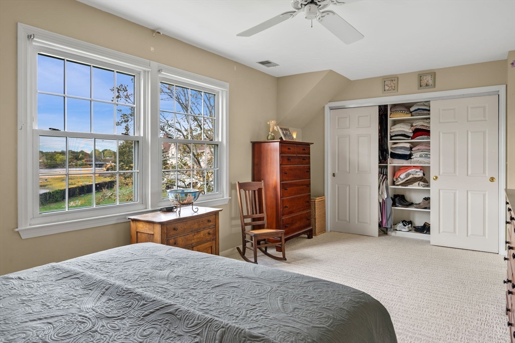 33 Water Street, Unit 7 Danvers, MA 01923 - Photo 21 of 35 a bedroom with a bed a standing and a large window
