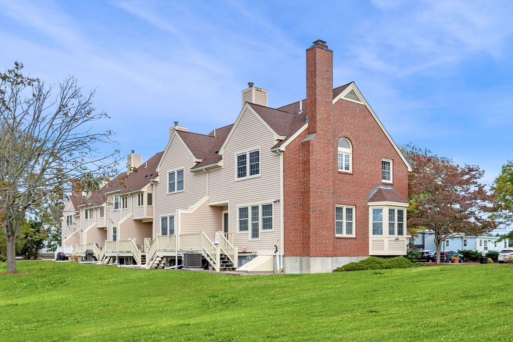33 Water Street, Unit 7 Danvers, MA 01923 - Photo 24 of 35 a front view of a house with a garden and yard