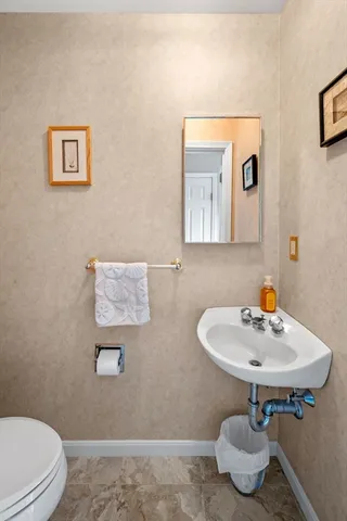 a bathroom with a sink toilet and mirror