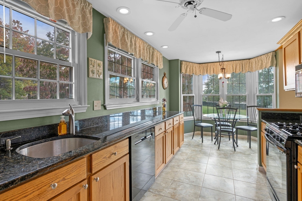 33 Water Street, Unit 7 Danvers, MA 01923 - Photo 5 of 35 a kitchen with granite countertop a sink and a stove