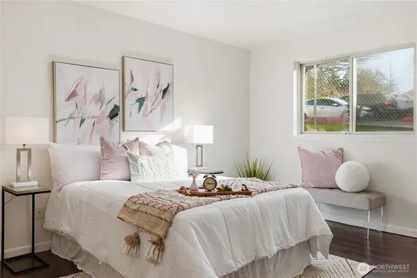 a bedroom with a bed and wall painting