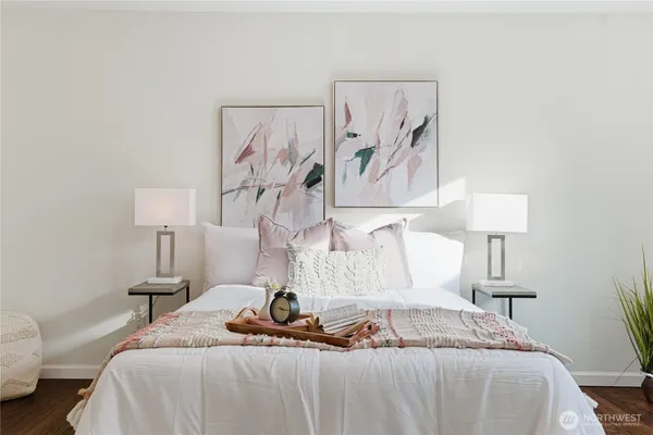 a bedroom with a bed and a potted plant