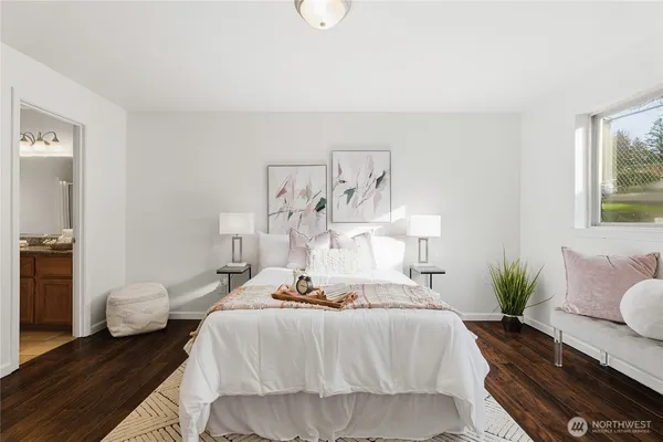 a bedroom with a bed and a lamp on table